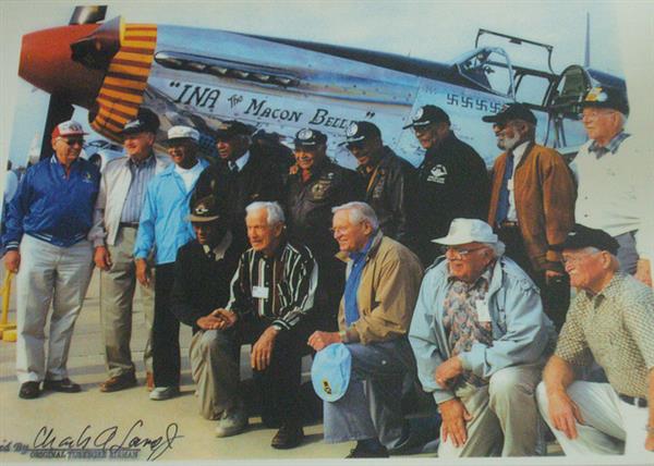 Elderly Tuskegee Airmen reunite with each other in front of a plane